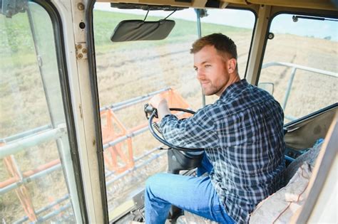 Premium Photo Farmer Controls The Combine Harvester