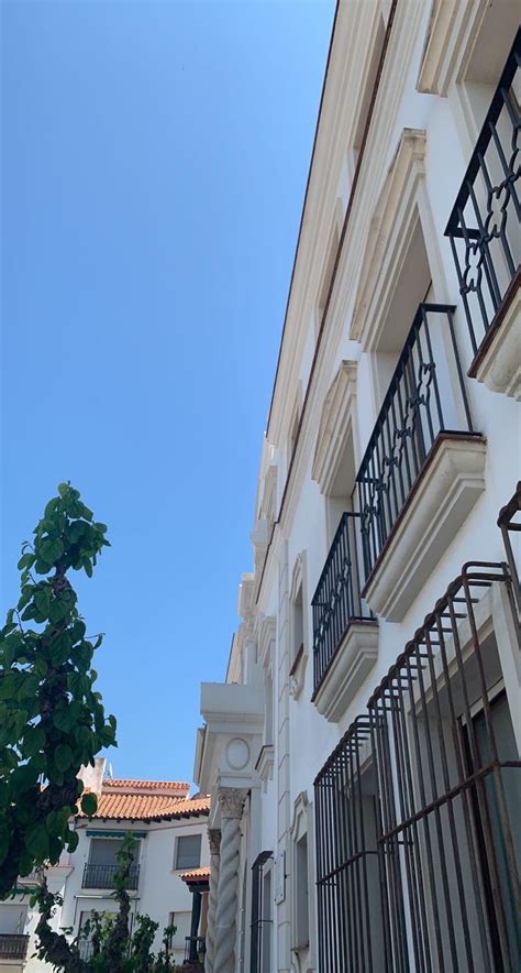 An Apartment Building With Balconies And Wrought Iron Railings On The