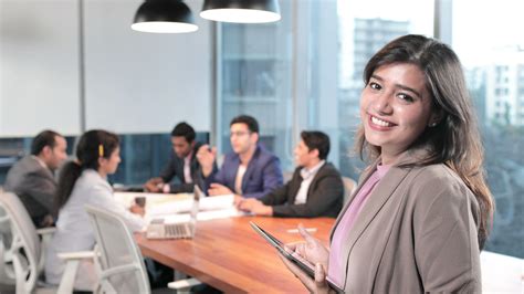 A beautiful office employee smiling at modern corporate office with colleagues Stock Footage,# ...