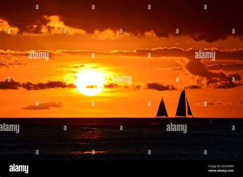 Boats silhouettes at Waikiki Beach sunset Hawaii Stock Photo - Alamy