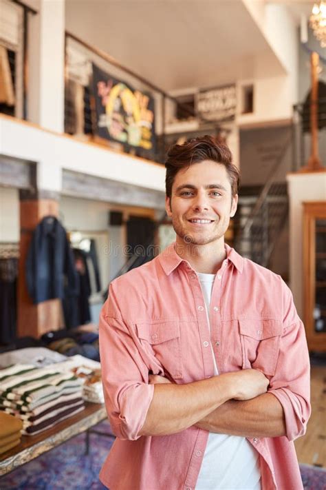 Male Owner Of Fashion Store Using Digital Tablet To Check Stock In