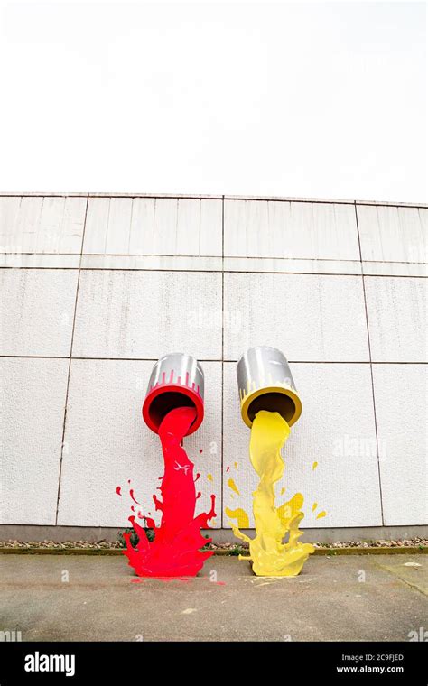 Two Metal Buckets Pouring Red And Yellow Paint Stock Photo Alamy