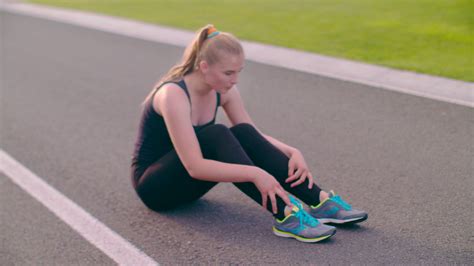 Tired Runner Sitting On Asphalt Road Exhausted Female Runner Breathing Hard After Running