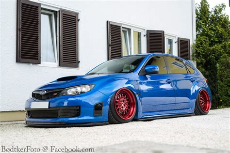 Slammed And Eye Catching Blue Subaru Wrx On Custom Red Wheels Carid