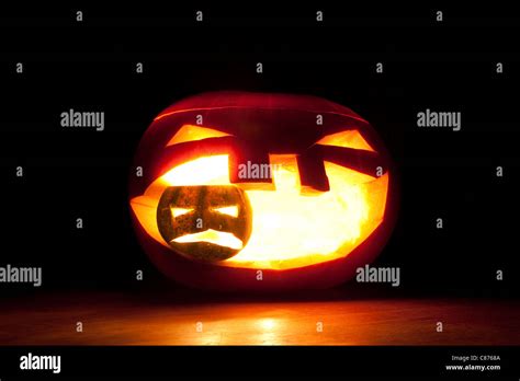 Halloween Pumpkin Eating Up Smaller Pumpkin On Black Stock Photo Alamy