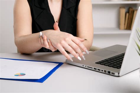 Female Feeling Pain In Wrist After Working On Laptop Stock Photo