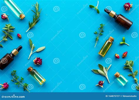 Natural Wellness Essential Oils Near Herbs And Leaves On Blue