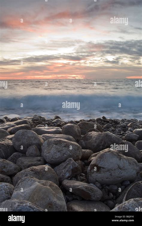 Sunset On A Pebble Beach Stock Photo Alamy