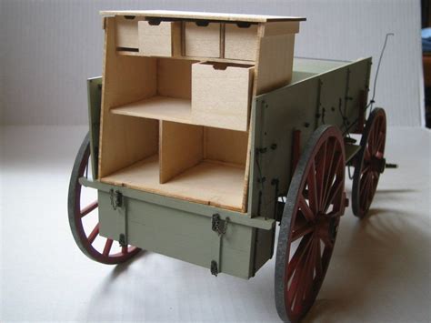 An Old Fashioned Wooden Toy Carriage With Open Shelves