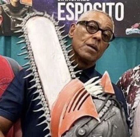 Two Men Standing Next To Each Other Holding Giant Chainsaws