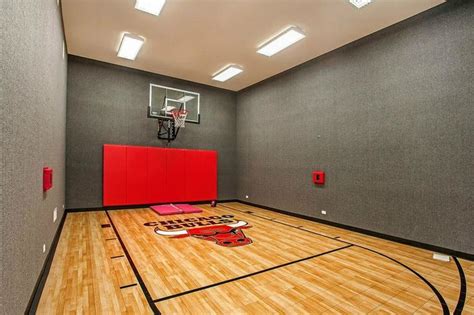 An Indoor Basketball Court With Red And Black Accessories On The Floor