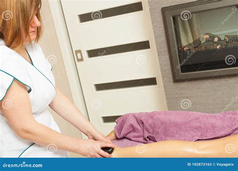 Masseuse Doing Legs Massage With Hot Stones Stock Image Image Of