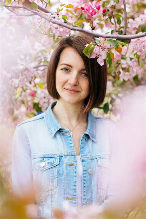 Close Up Portrait Of A Beautiful Girl With Pink Hair Standing In A