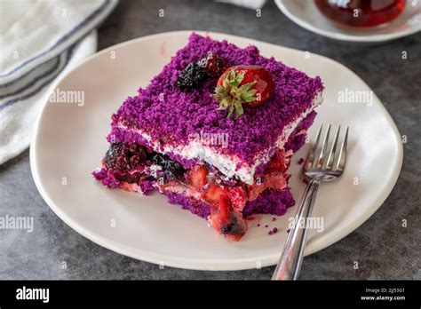 Fruit cake slice. Forest fruit cake on a dark background. Bakery products. side view. Close-up ...