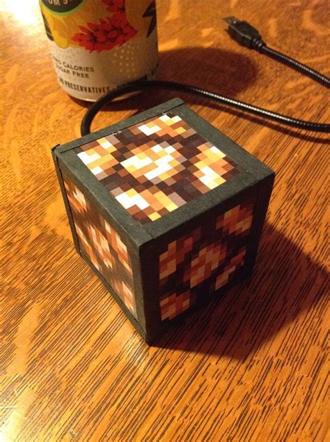 A Wooden Table Topped With A Lit Up Box On Top Of Its Side