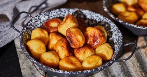 Two Bowls Filled With Fried Potatoes Sitting On Top Of A Wooden Table