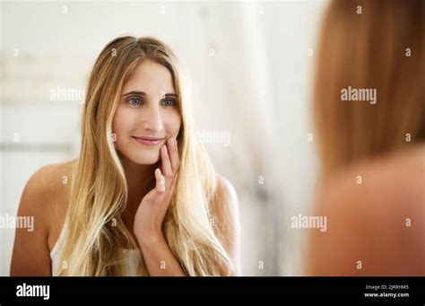 Skin So Healthy It Glows A Young Woman Admiring Her Perfect Skin In