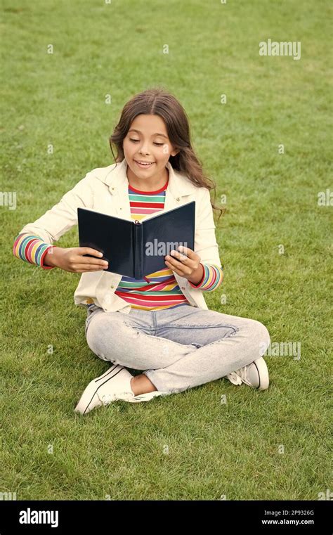 Inspired Teen Girl Read Book Sitting On Grass Reading Book Reader