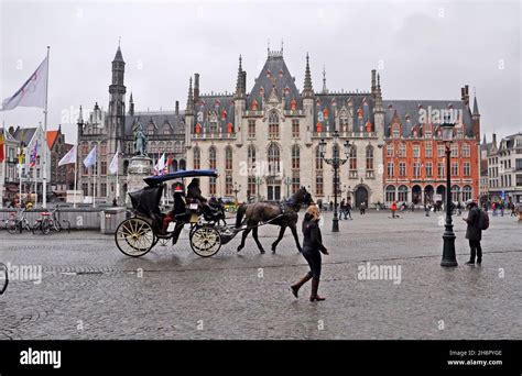 The Historic Centre Of Bruges In Belgium With A Horse Drawn Carriage