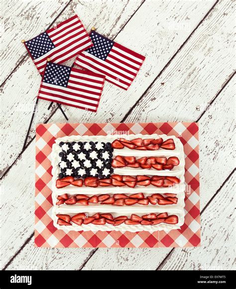 Patriotic American flag cake and decorative mini flags on vintage wooden background Stock Photo ...