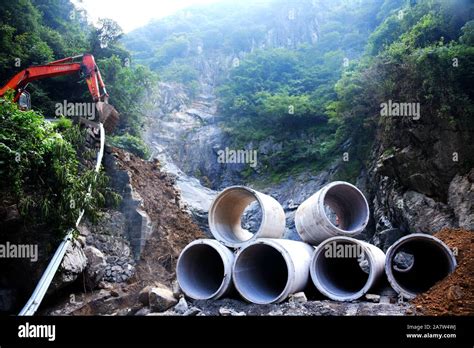 Chinese Workers Reconstruct A Road Devastated By Floodwater After Heavy