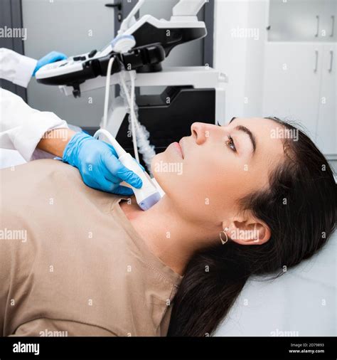 Female Patient Receives Thyroid Diagnostics At A Medical Clinic