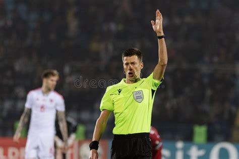 Referee In Yellow Has Hand Up To Signal To The Crowd Editorial