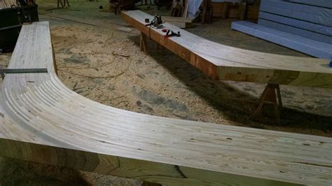 Several Wooden Benches Sitting On Top Of A Sandy Ground