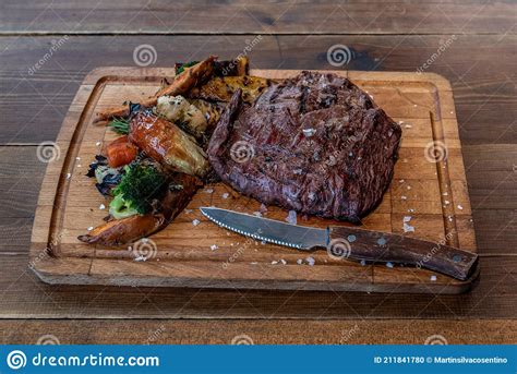 Argentine Cut Of Meat Called Vacio With Chorizos And Chimichurri Stock