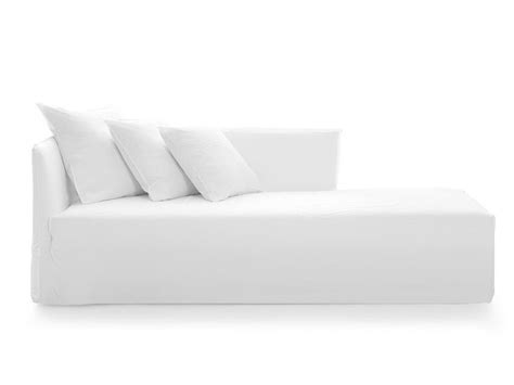 A White Couch With Four Pillows On It S Back And One Arm Facing The Camera