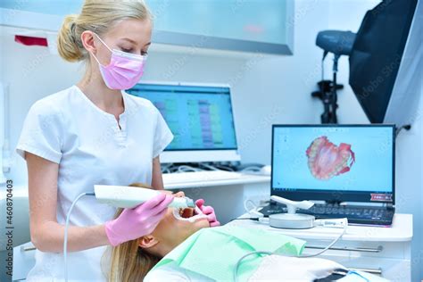 Dentist Scaning Patient With Dental Intraoral Scanner And Controls