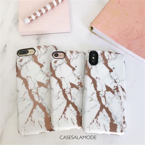 Three Marble Iphone Cases Sitting On Top Of A Table