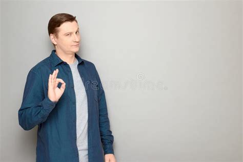 Portrait Of Confident Mature Man Showing Okay Gesture And Smiling Stock