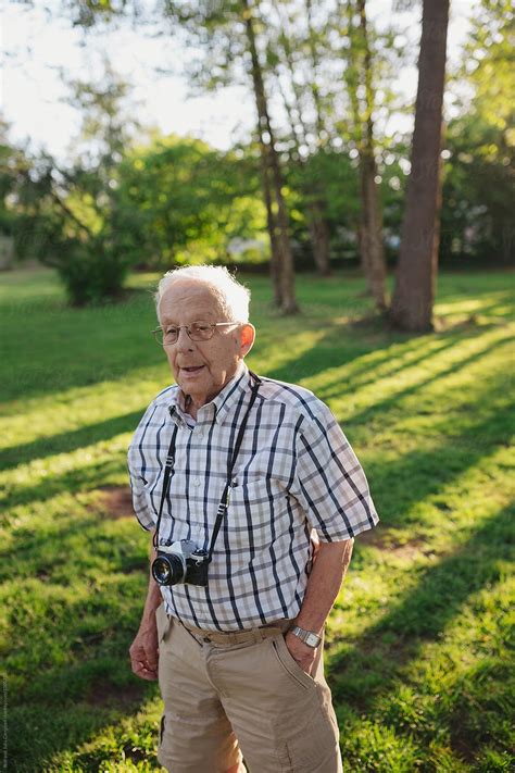 Old Senior Man Taking Pictures With Old Slr Film Camera Del