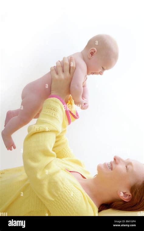 Mother Holding Nude Baby Playing White Background Stock Photo Alamy