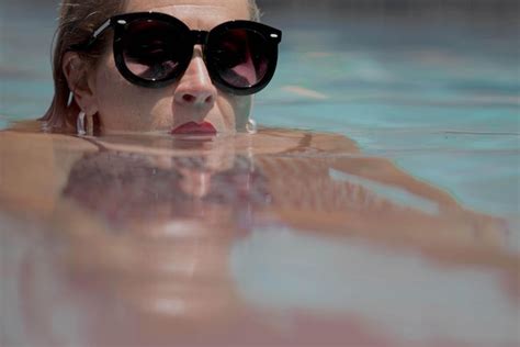 Premium Photo Portrait Of Woman Wearing Sunglasses In Swimming Pool