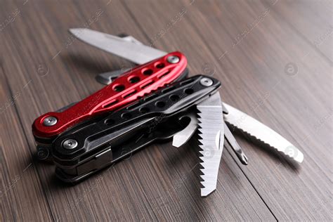 Modern Compact Portable Multitool On Wooden Table Stock Photo