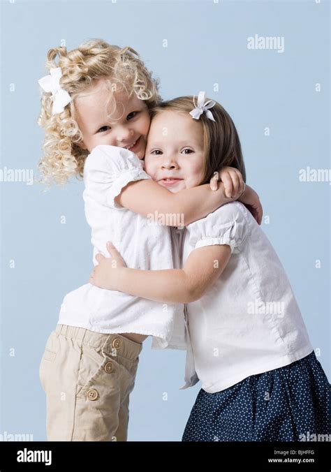 two little girls hugging Stock Photo - Alamy