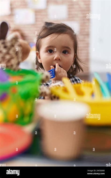 Adorable Chinese Girl Playing With Play Kitchen Sucking Fork Toy At