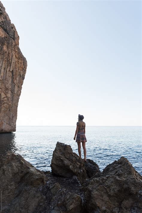 Woman Beach Looking At Rock Del Colaborador De Stocksy Milles Studio