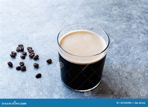 Frothy Cold Brew Nitro Coffee With Beans Ready To Drink Stock Photo