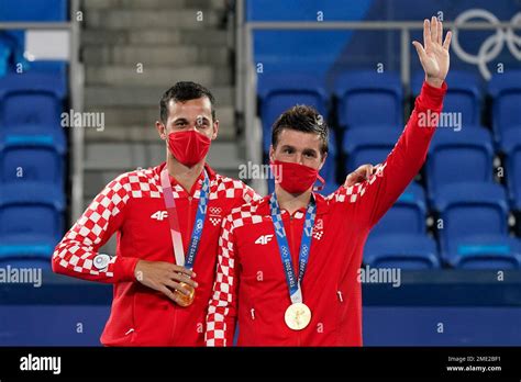 Mate Pavic Left And Nikola Mektic Of Croatia Pose With Their Gold