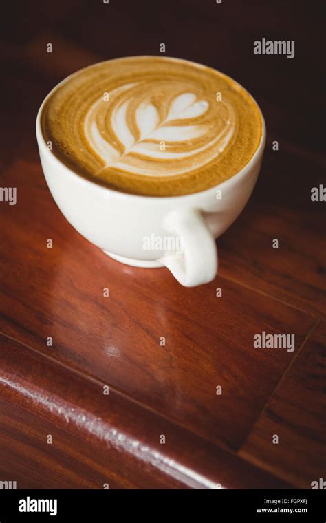 Cup Of Cappuccino With Coffee Art On The Counter Stock Photo Alamy