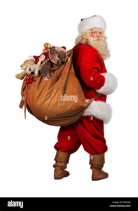 Full Length Portrait Of Real Santa Claus Carrying Big Bag Full Of Gifts