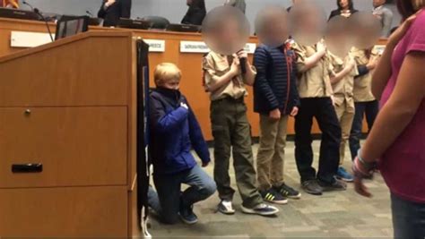 10-year-old Cub Scout takes a knee during the Pledge of Allegiance