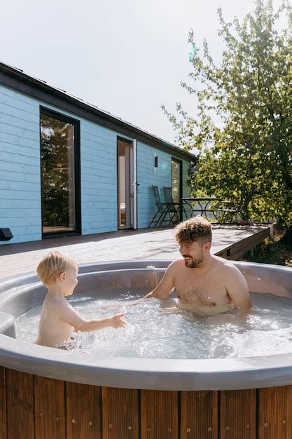 Premium Photo Father And Son Bonding In Backyard Hot Tub Splashing Water Enjoying Outdoor