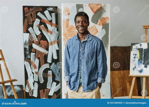 Young Smiling African American Craftsman In Casualwear Standing In