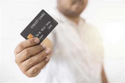 Close Up Hand Of Asian Man Holding Black Credit Card In His Hand