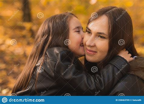 Mother And Daughter Spend Time Together In Autumn Yellow Park Season