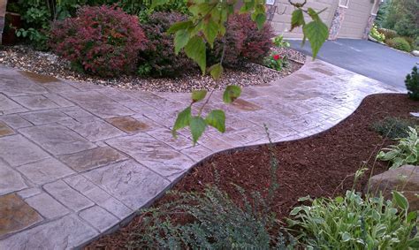 A Stamped Dyed Patio Natural Elements Lawn And Landscape Installed In